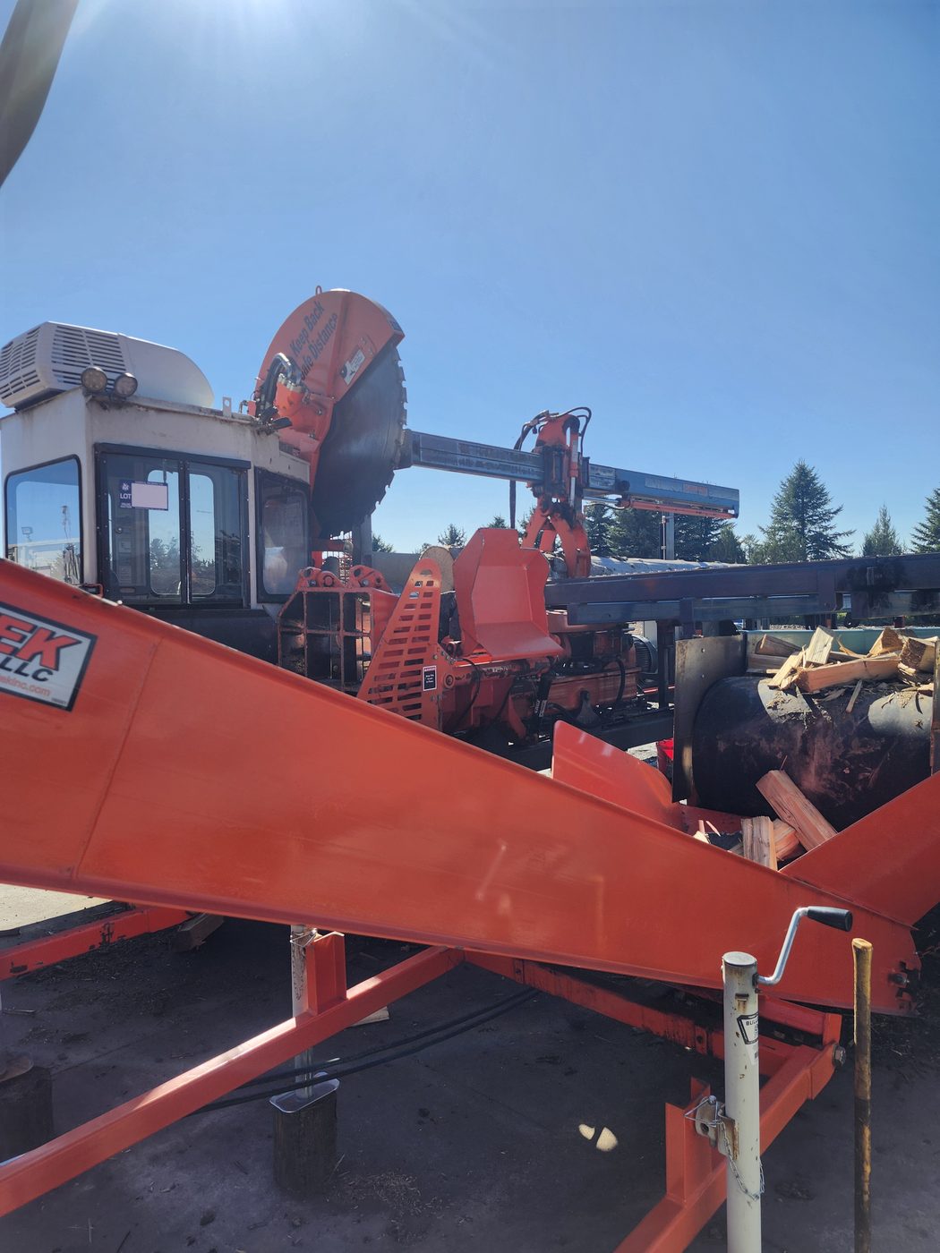 One of our firewood processors with its circular saw blade, parked on the lot