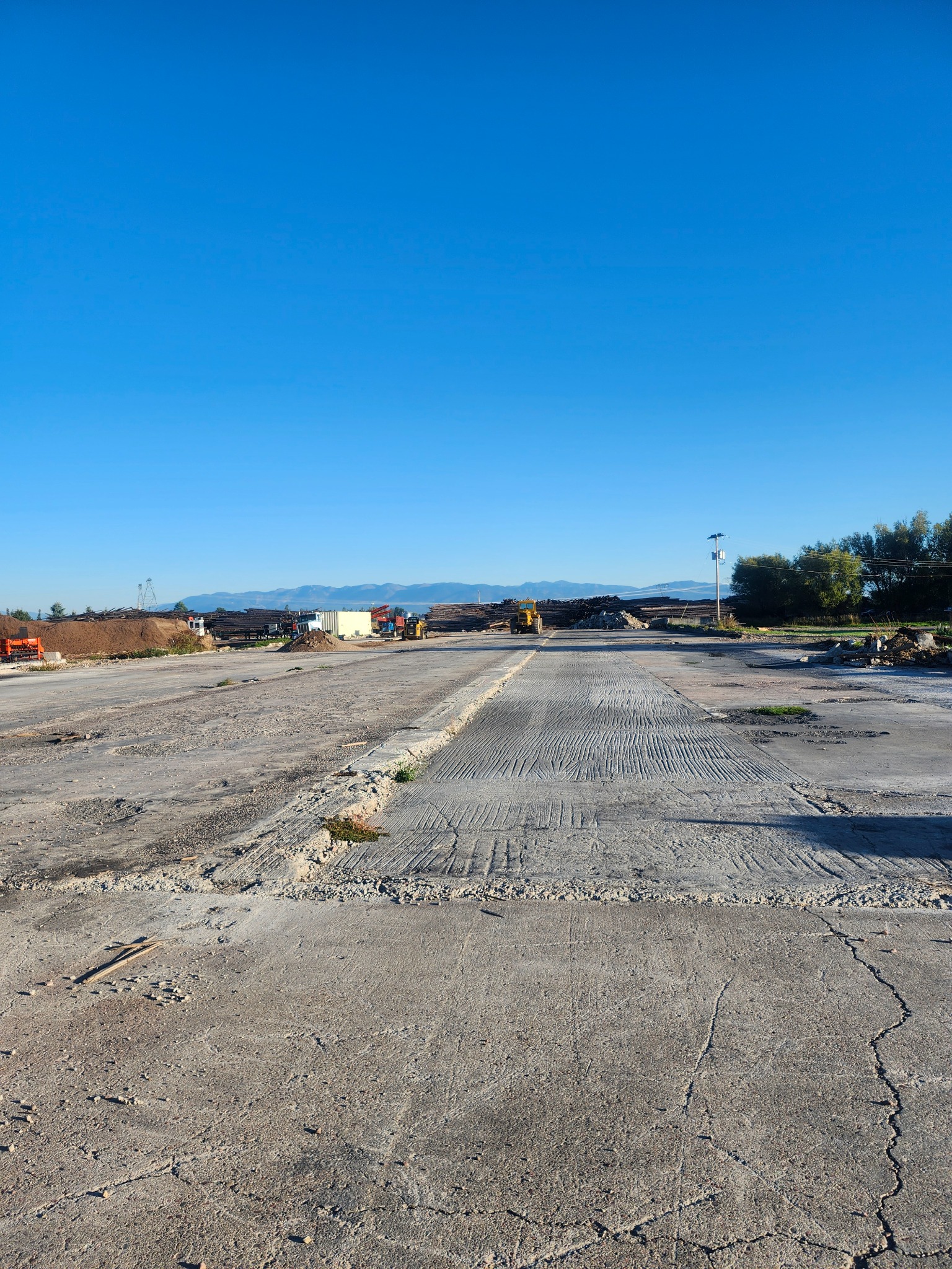 Wide view of the Montana Timberline Firewood lot today with mountains in the distance